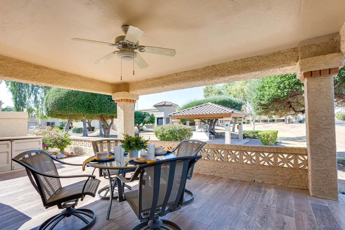 This image features a patio with a dining table and outdoor seating, set against a backdrop of landscaped greenery. The layout suggests an inviting space for outdoor dining or relaxing while taking in the view, perfectly matching the section's emphasis on al fresco meals and resort-style leisure.